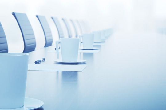 row of coffee cups on a conference table