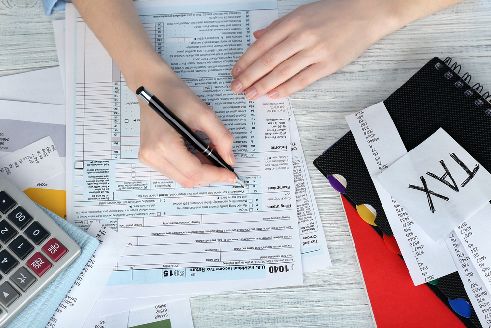 Woman filling form of Individual Income Tax Return
