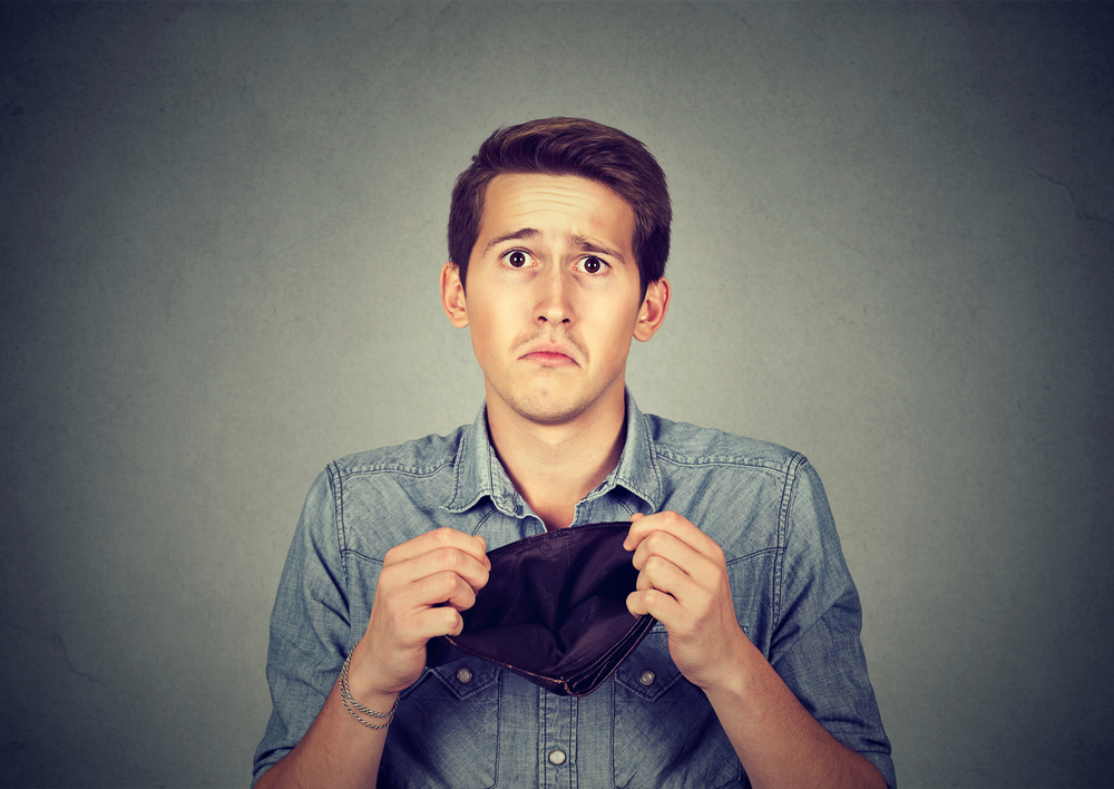 Businessman holding empty wallet