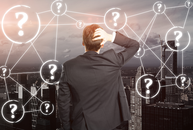 person standing around question marks 